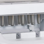 Close-up of ice cube machine inner tubes and dispensing area