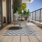 Reversible outdoor rug mat with light grey and white zigzag chevron pattern