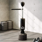 Black freestanding boxing speed bag stand with rotating arm and weighted base