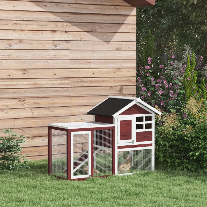 Outdoor rabbit hutch and small run with black roof, maroon walls, white trim, mesh