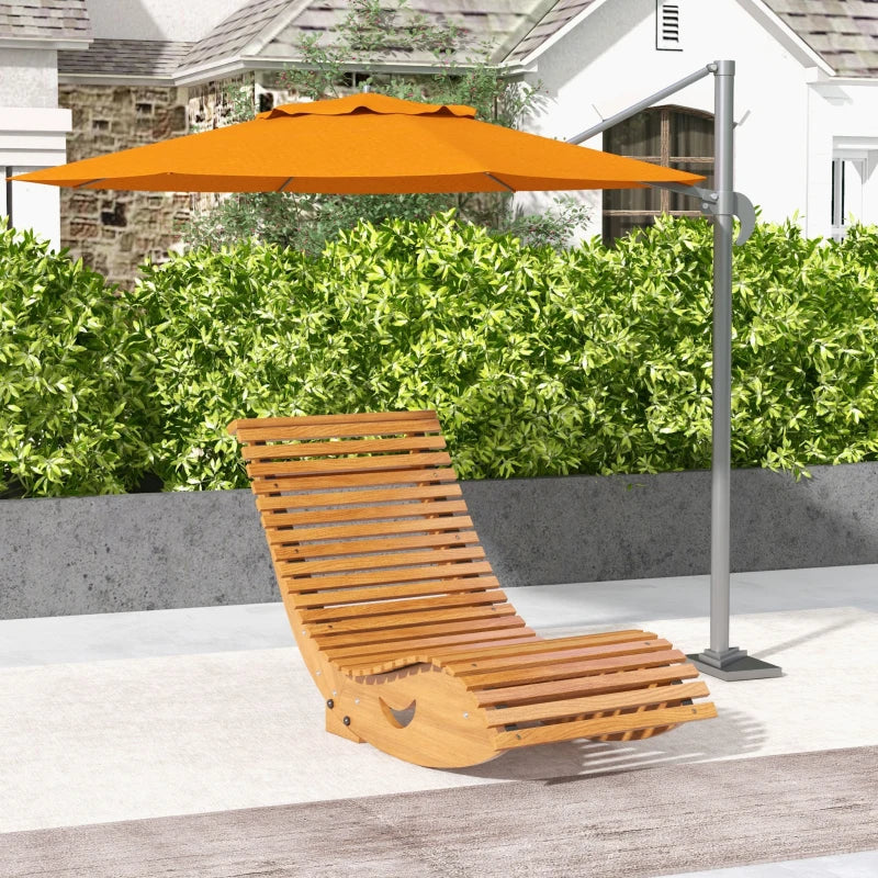 Outdoor light brown wooden rocking chair with slatted back and seat under an umbrella