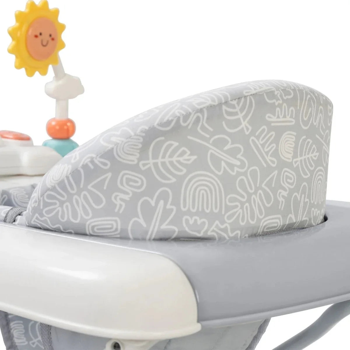 Grey patterned padded cushion on infant walker with white tray edge and toy