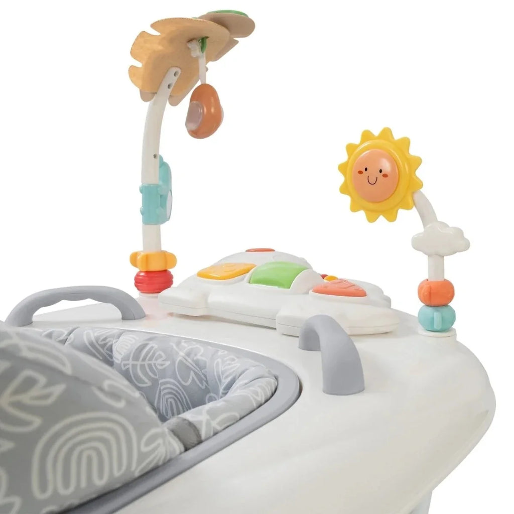 Infant activity walker with hanging sun and leaf toys above white play tray