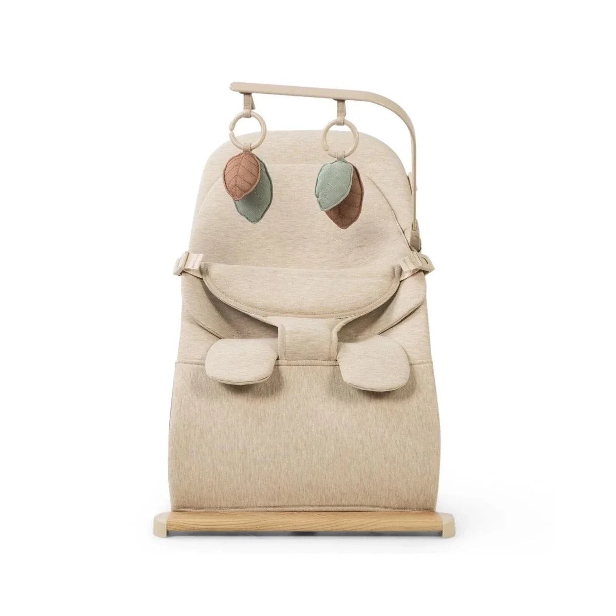 Oatmeal baby bouncer with front view harness pads, two hanging leaf toys, and wooden stand