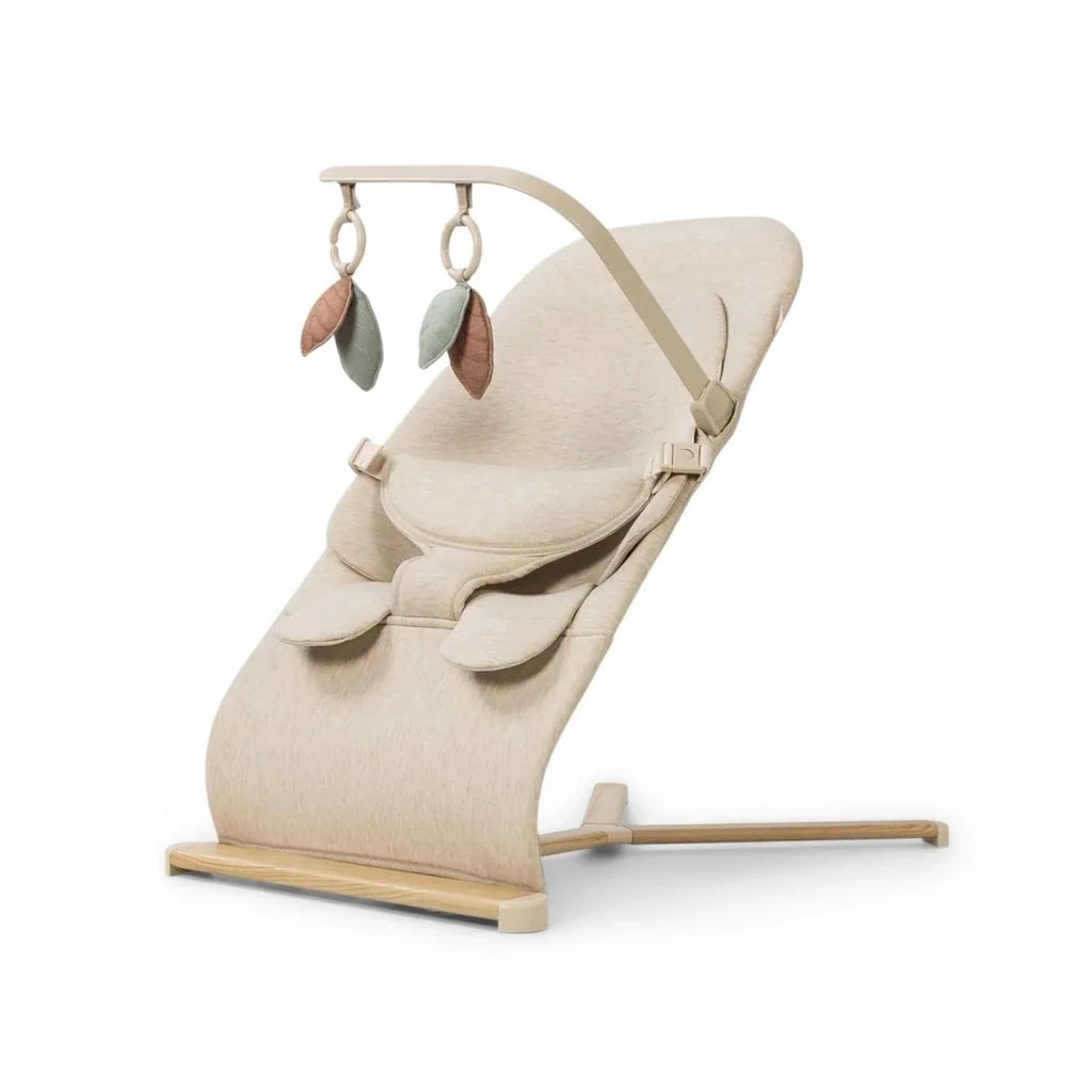 Oatmeal baby bouncer with hanging leaf toys and wooden base