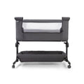 Grey fabric bedside crib with padded rail and adjustable legs