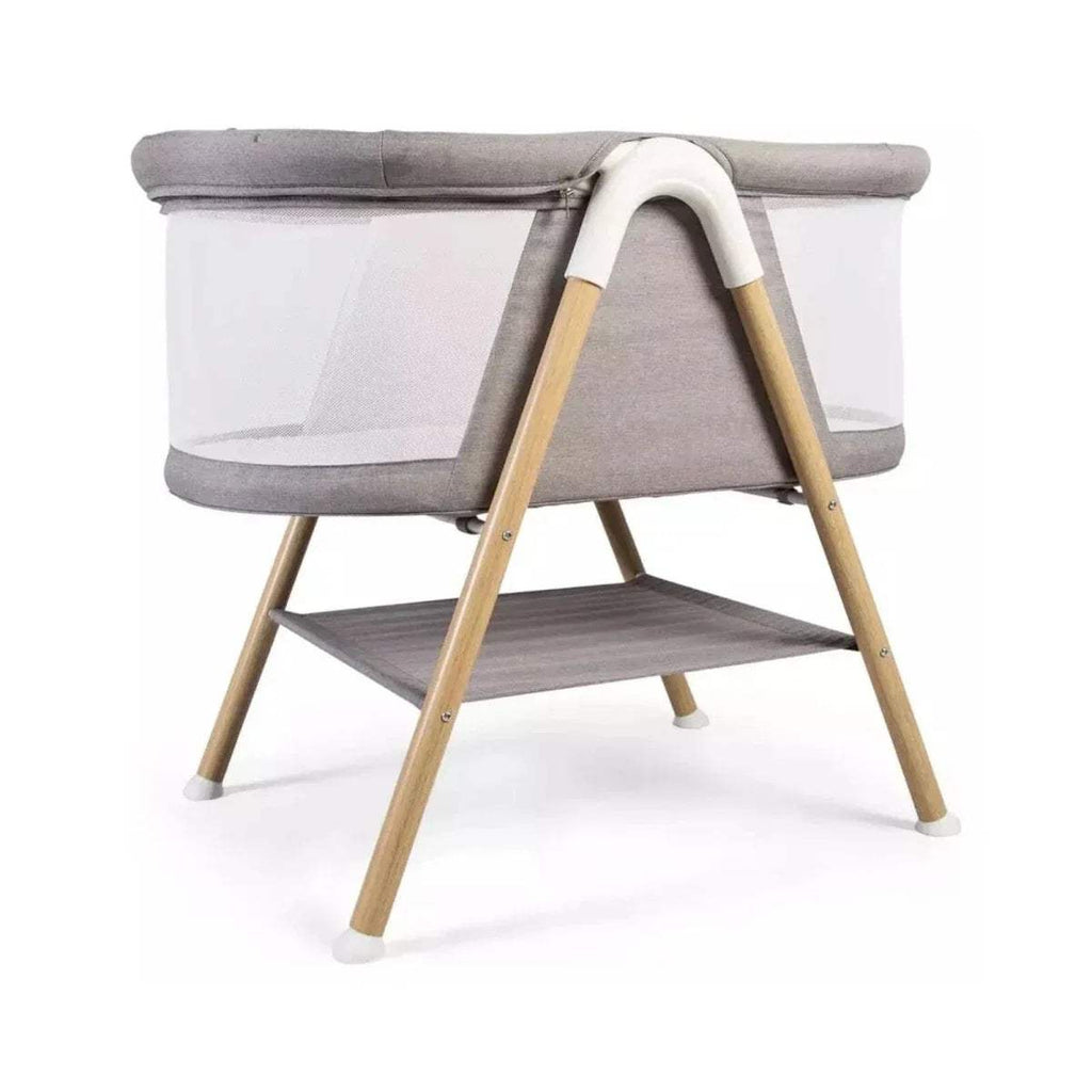 Grey fabric snooze crib with white side panels, wooden legs, open bassinet.
