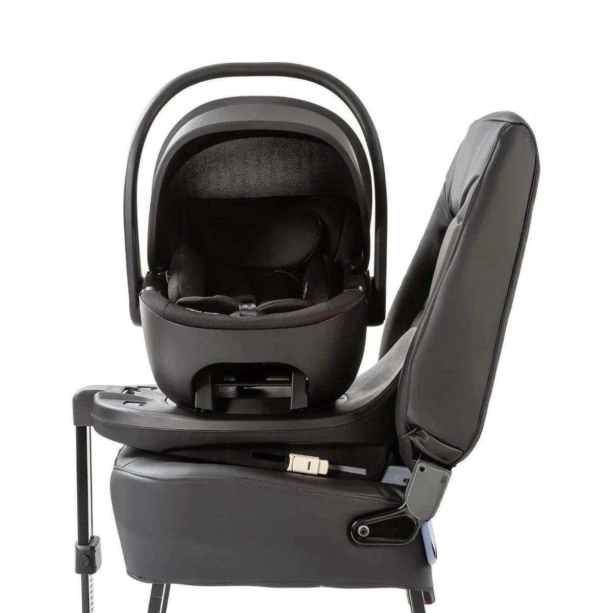 Black ISOFIX child seat base with installed seat shell and recline arm