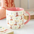 Cowboy boot print mug with pink interior, cream body, red boot and cactus pattern