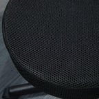 Close-up of black textured padded round stool seat cover