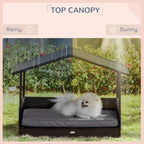 Grey elevated dog bed with canopy roof and cushioned base, fluffy dog resting