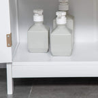 White bathroom cabinet interior shelf with bottles and soap dispensers.