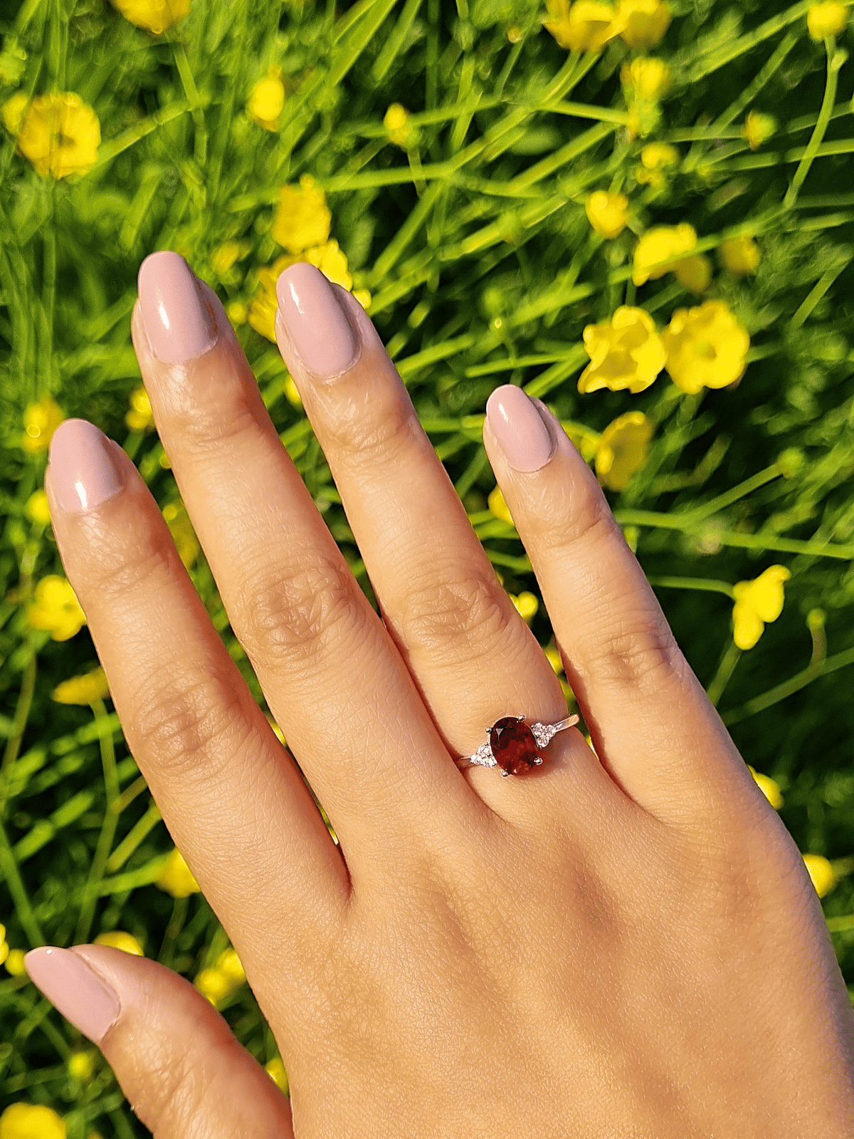Sterling silver garnet ring on a hand
