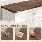 Brown tabletop edge on a white sideboard with a gold drawer pull.
