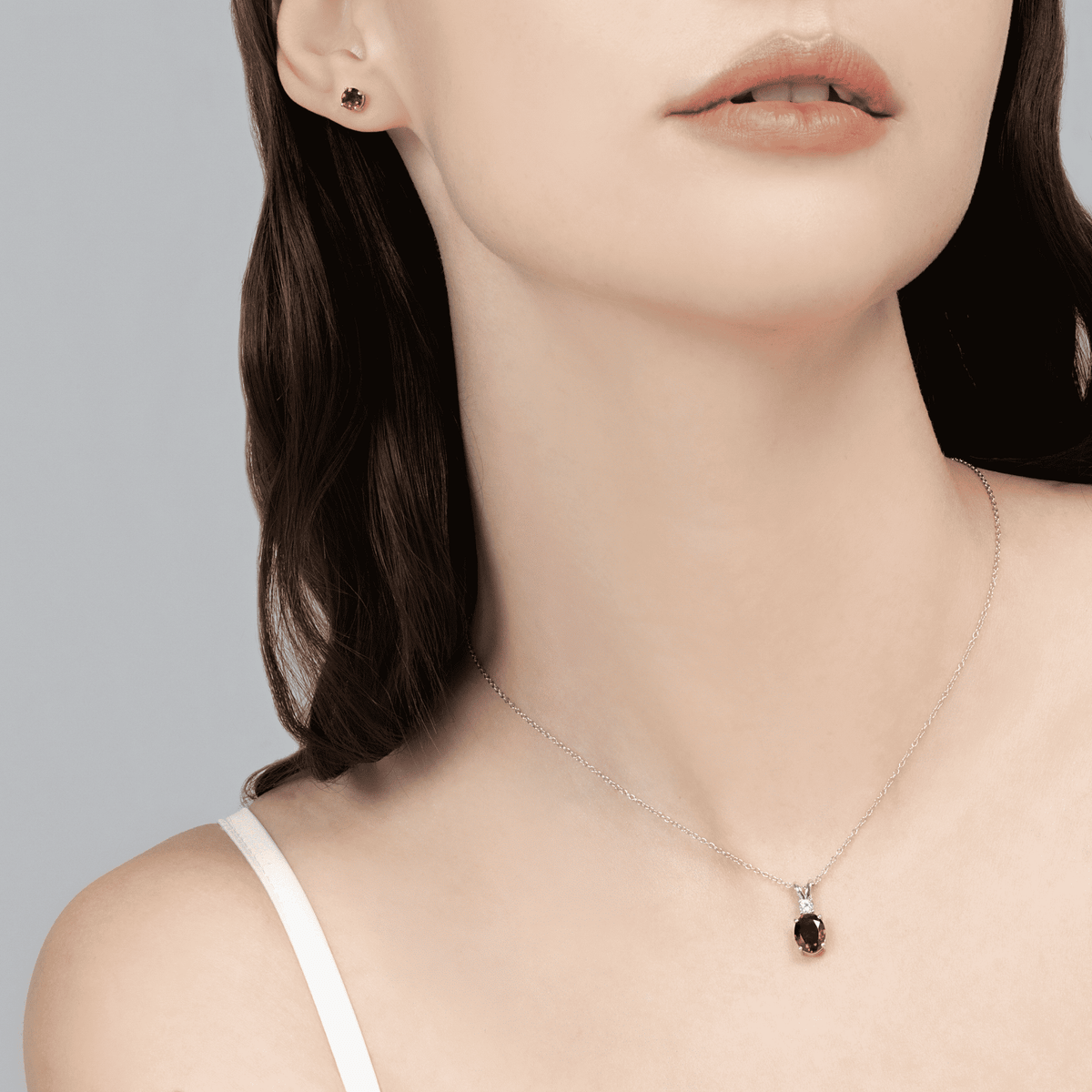 Sterling silver chain necklace with a small round red-garnet pendant