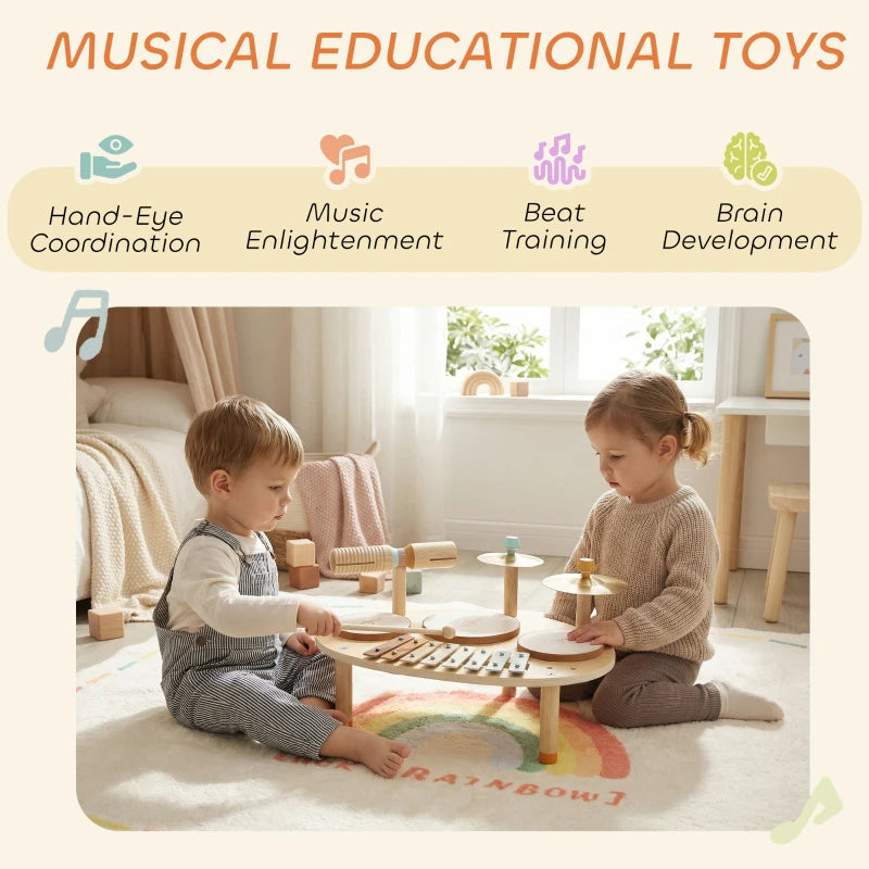 Children playing a wooden musical table with three drums, cymbals, and xylophone keys