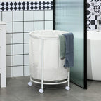 White wheeled laundry bin with open fabric liner and a towel hanging over the rim