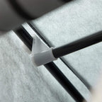 Light grey fabric wardrobe shelf support bar with connector clip, close-up.