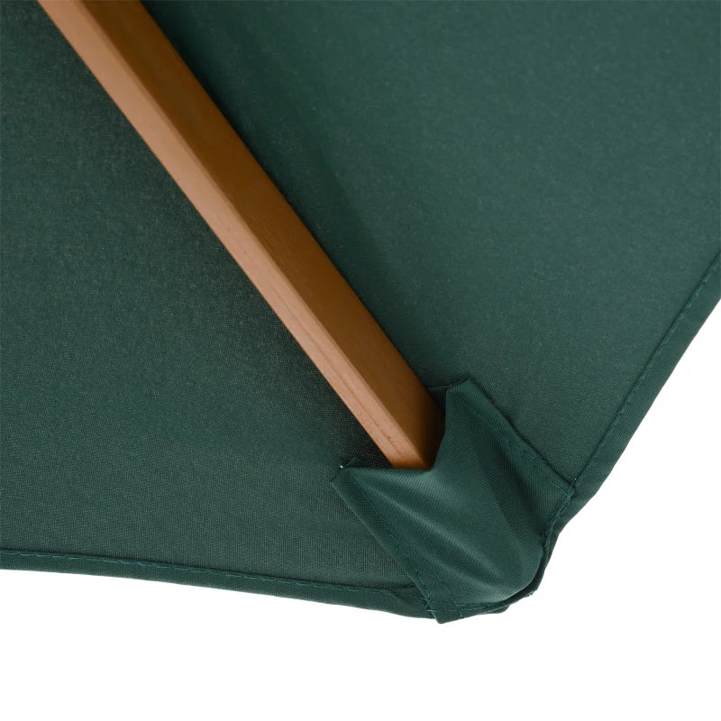 Close-up of a green umbrella with a wooden handle on a white background