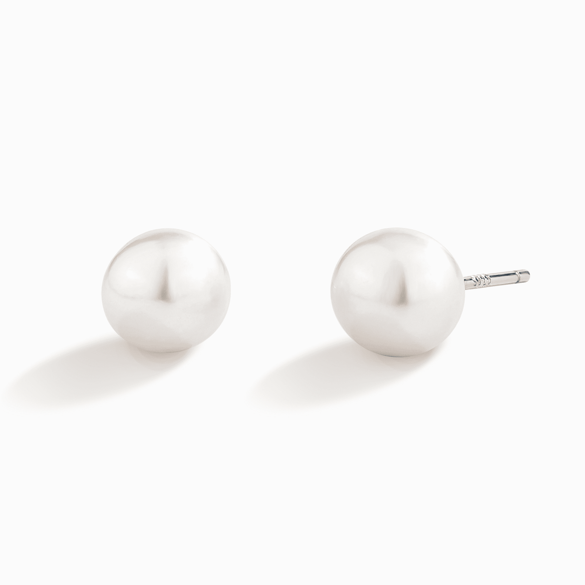 Sterling silver stud earrings with round white freshwater pearls and butterfly backs