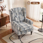 Plaid wingback accent chair with cushioned seat, wing arms, and dark turned legs