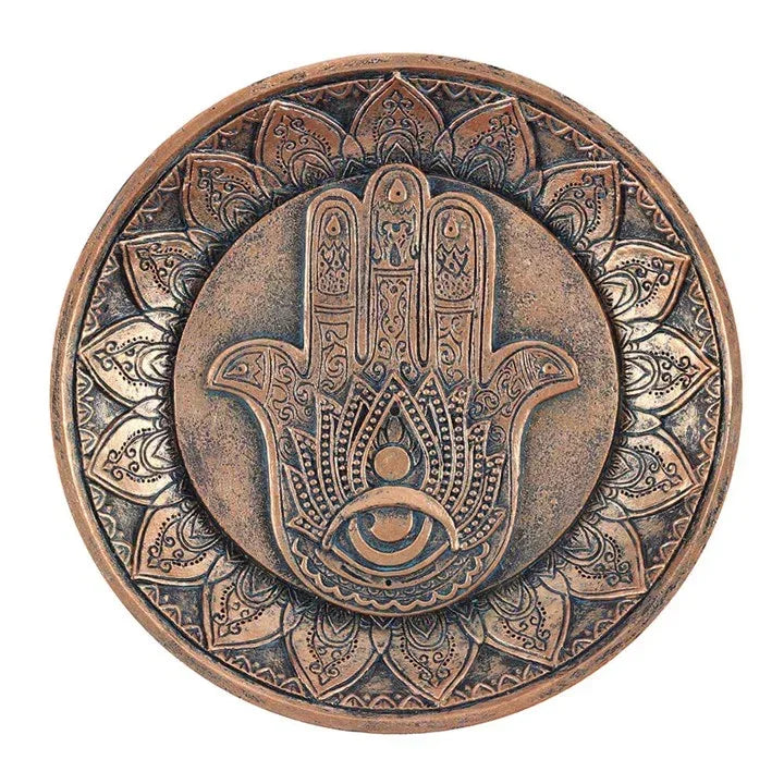 Round incense holder plate with hand of Hamsa design, circular patterned rim, bronze tone