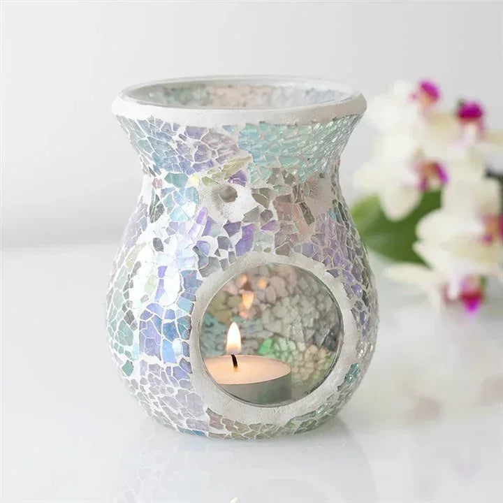 Iridescent crackle mosaic wax warmer with lit candle in round front window, teal tones.