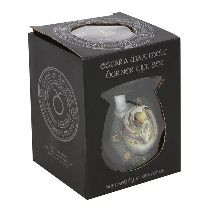 Black gift box with window showing black wax melt burner and dragon emblem