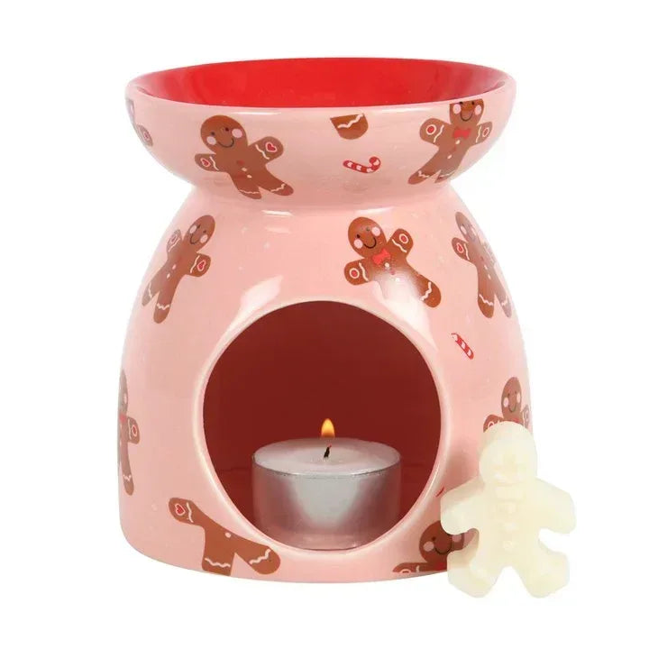 Gingerbread wax melt burner with lit wax flame, gingerbread pattern, heart cutouts