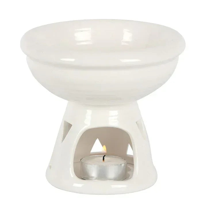 Off-white oil burner and wax warmer with cut-out sides and lit tealight in metal cup