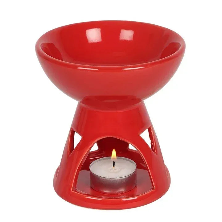 Red oil/wax burner with open bowl, cutout sides, holding a tealight candle
