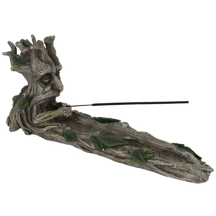 Gray resin incense stick holder shaped as a reclining tree spirit with green leaf accents
