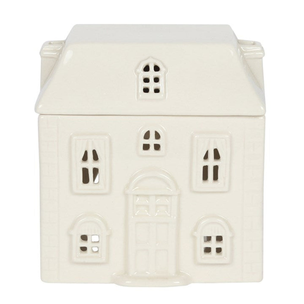 White ceramic house-shaped container with decorative windows on a white background