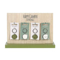 Happy Camper keyring set with four camp-themed metal charms and split rings on display