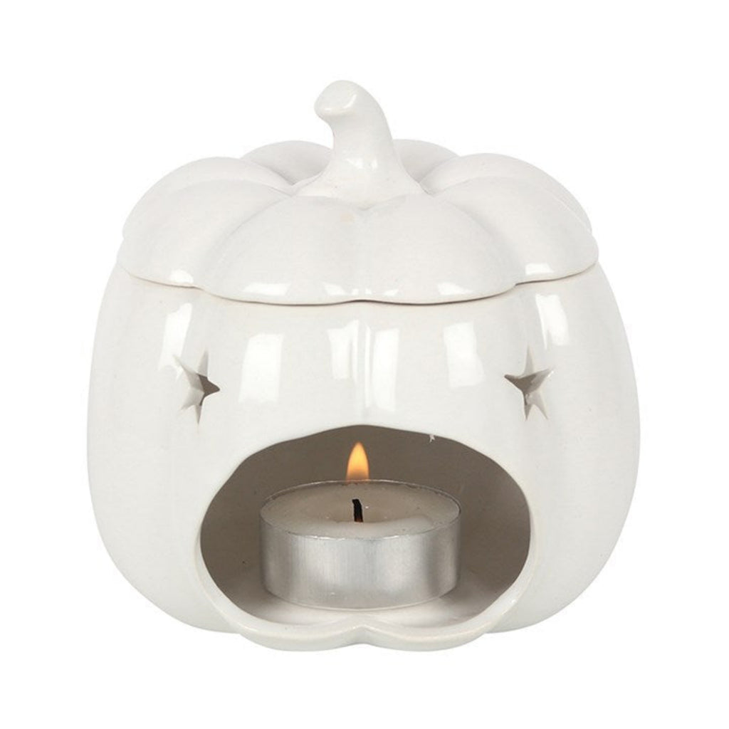 White ceramic oil burner with a lit tealight candle on a white background