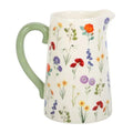 Ceramic flower jug with cream body, green handle, and colorful wildflower print