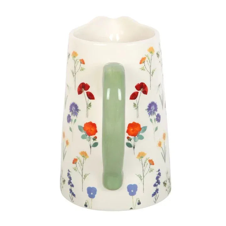 Ceramic flower jug with cream body, green pour spout, and wildflower pattern