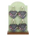 Set of four dark slate heart ornaments with wildflower print and jute twine loops