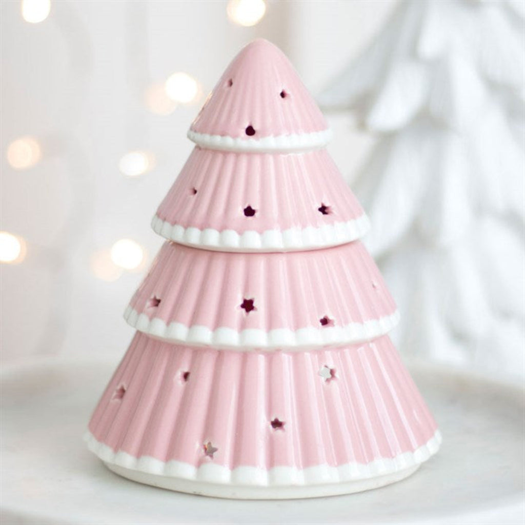 Pink pine tree-shaped candle holder with star cutouts on a white background