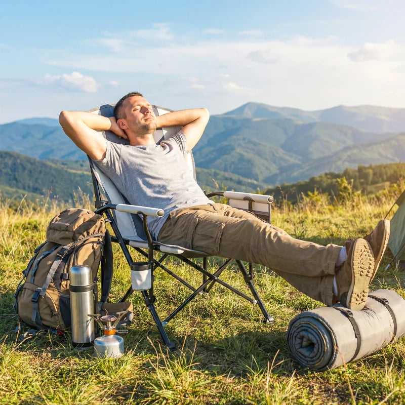 Light grey padded camping chair reclined on grass with side pocket and cup holder