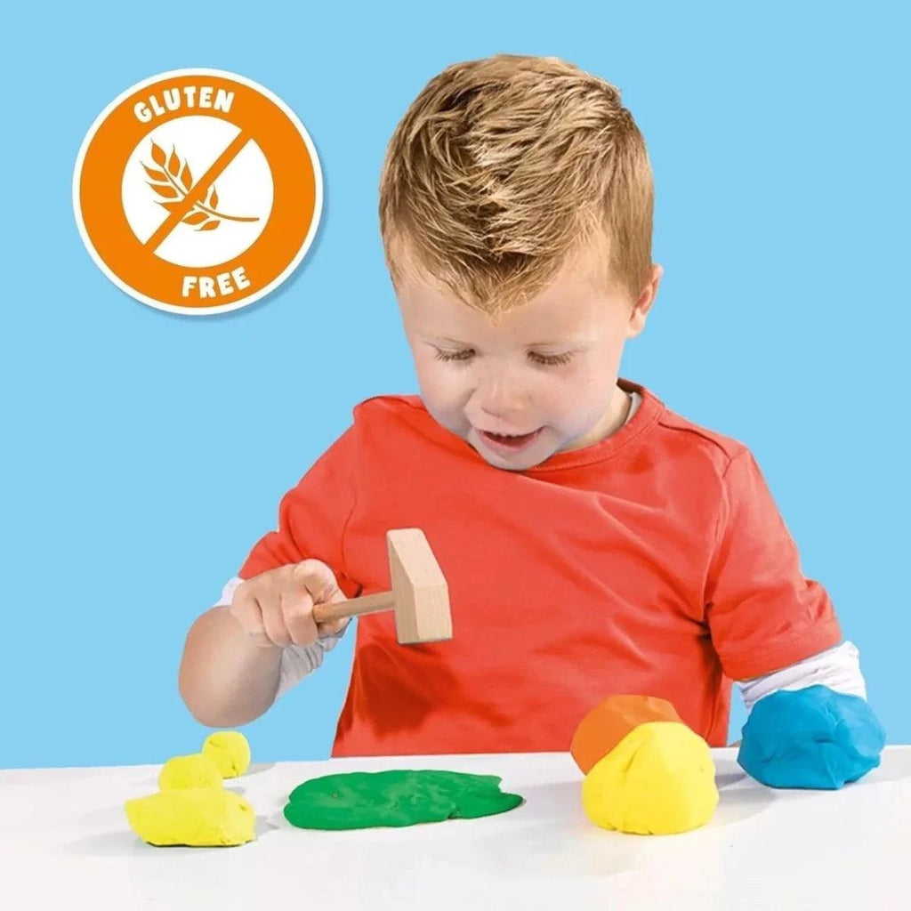 Child playing with playdough and wooden tool; orange shirt and gluten-free badge
