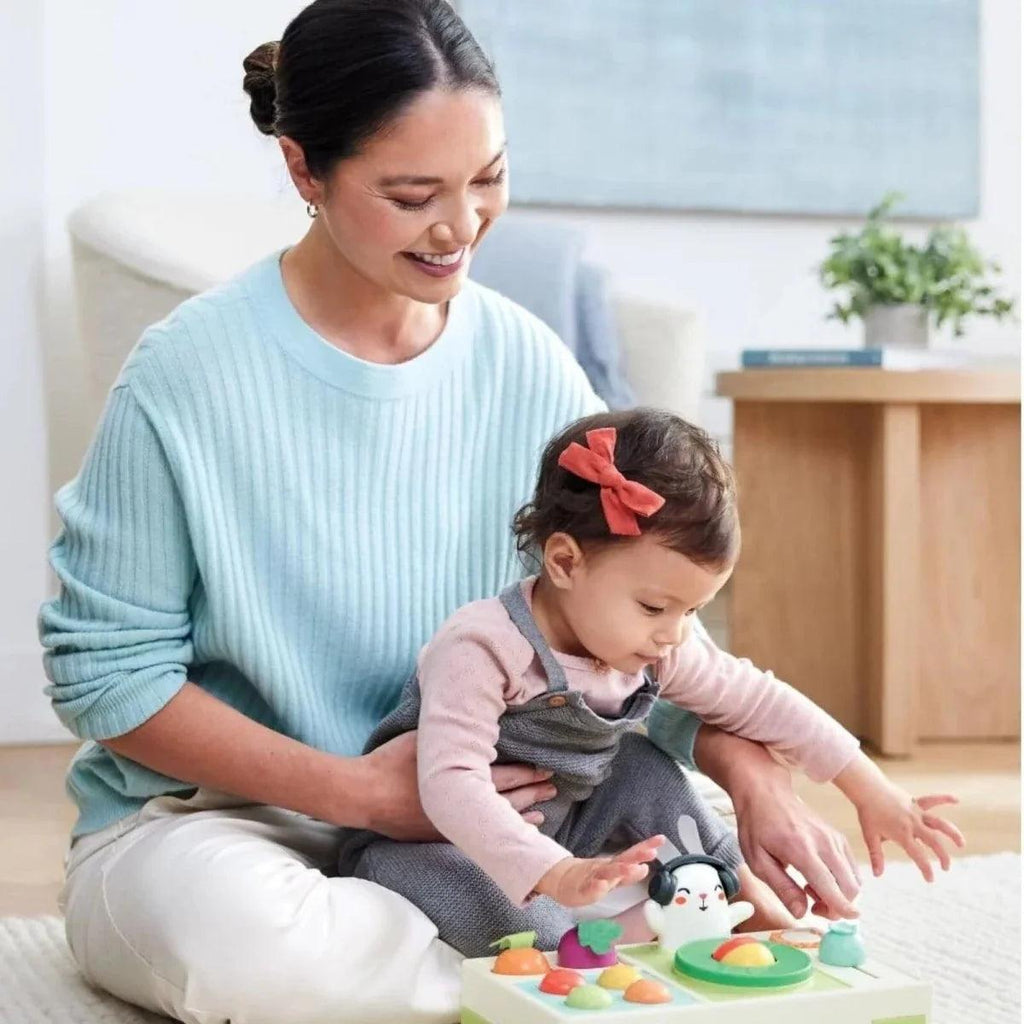 Child and adult using bunny DJ music toy with vegetable buttons and green turntable