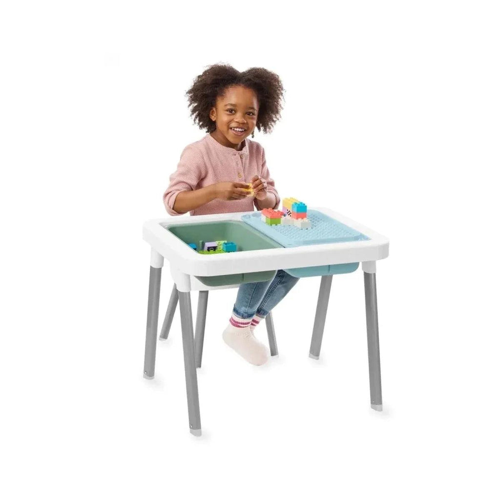 Children playing at white sensory table with blue-green bin and toys