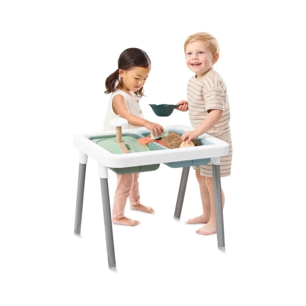 Two children using sensory table with blue-green bin and toy accessories