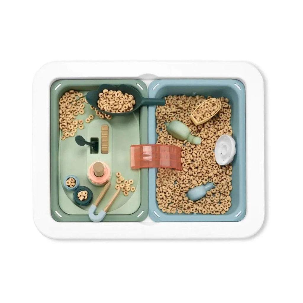 Pegboard insert filled with small colorful connectors and figures