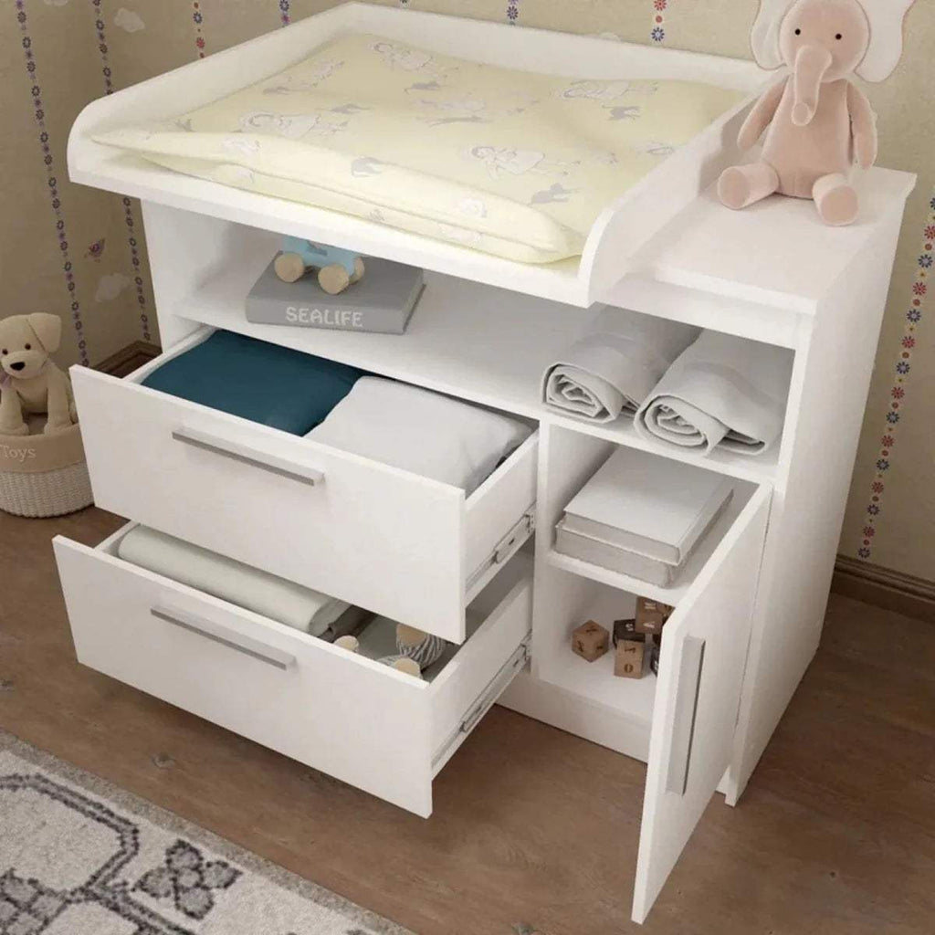 White kids changing unit open with drawers, shelves, and changing pad on raised ledge