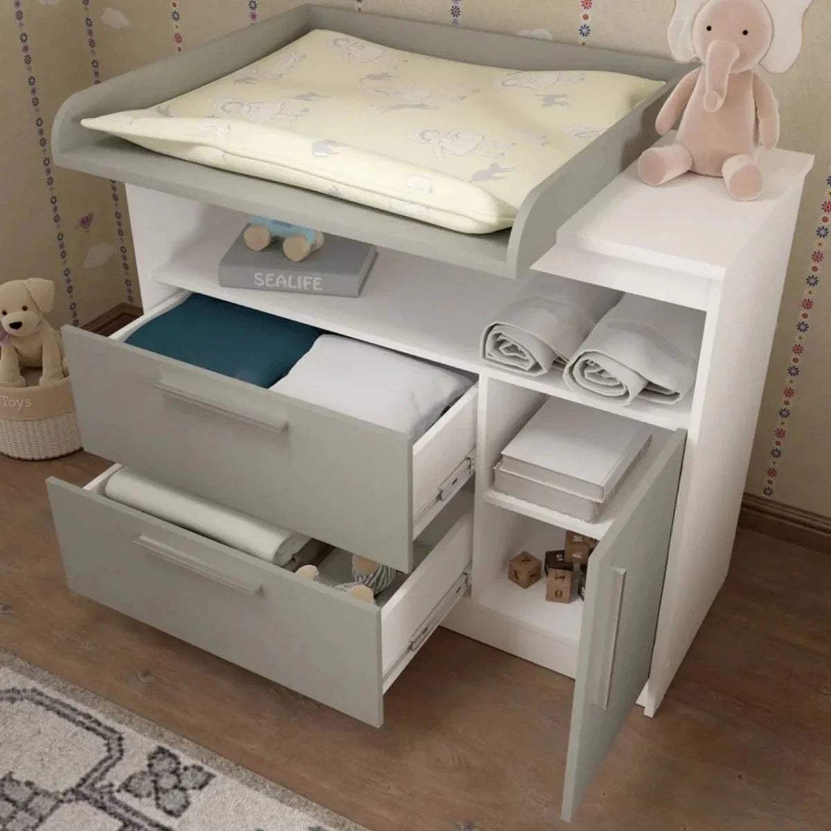 Grey and white changing unit with open cabinet, changing pad, and folded liners