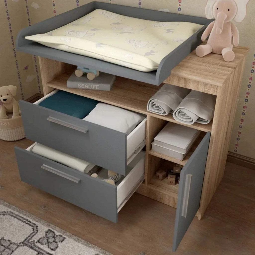 Kids changing unit with raised changing pad, open compartments, graphite drawers, oak frame.