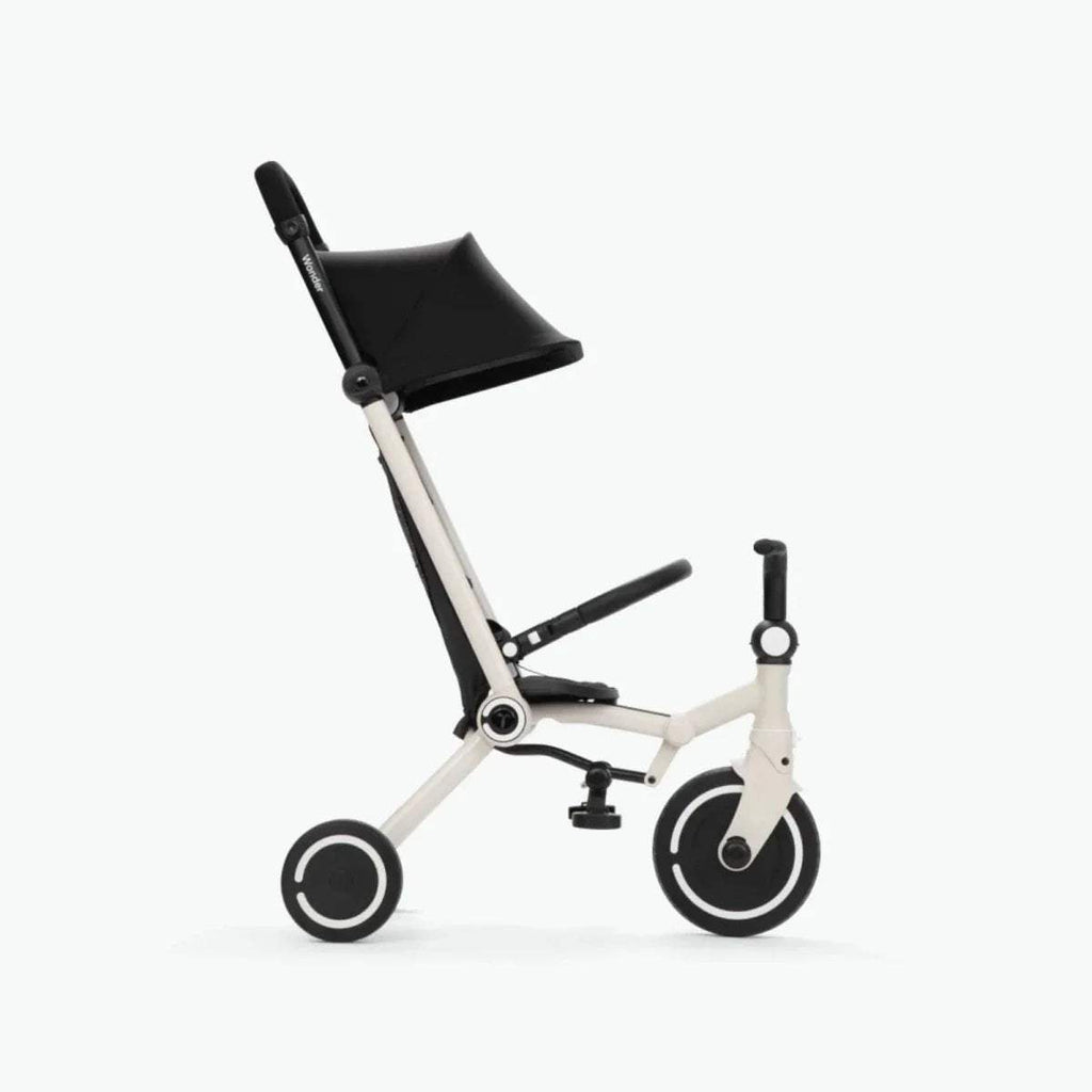 Black-and-white compact stroller with canopy, front wheel, and adjustable handlebar