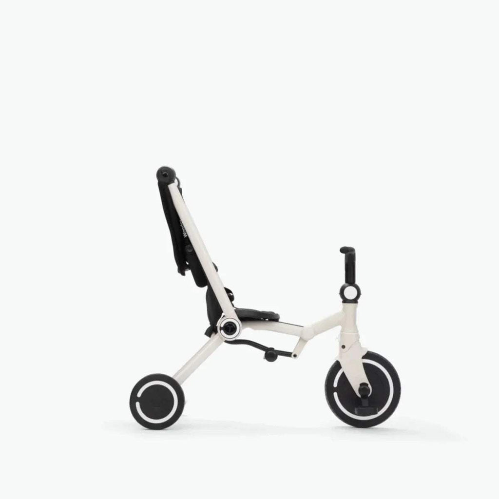 Black-and-white stroller in profile with canopy, mesh seat, and side wheels